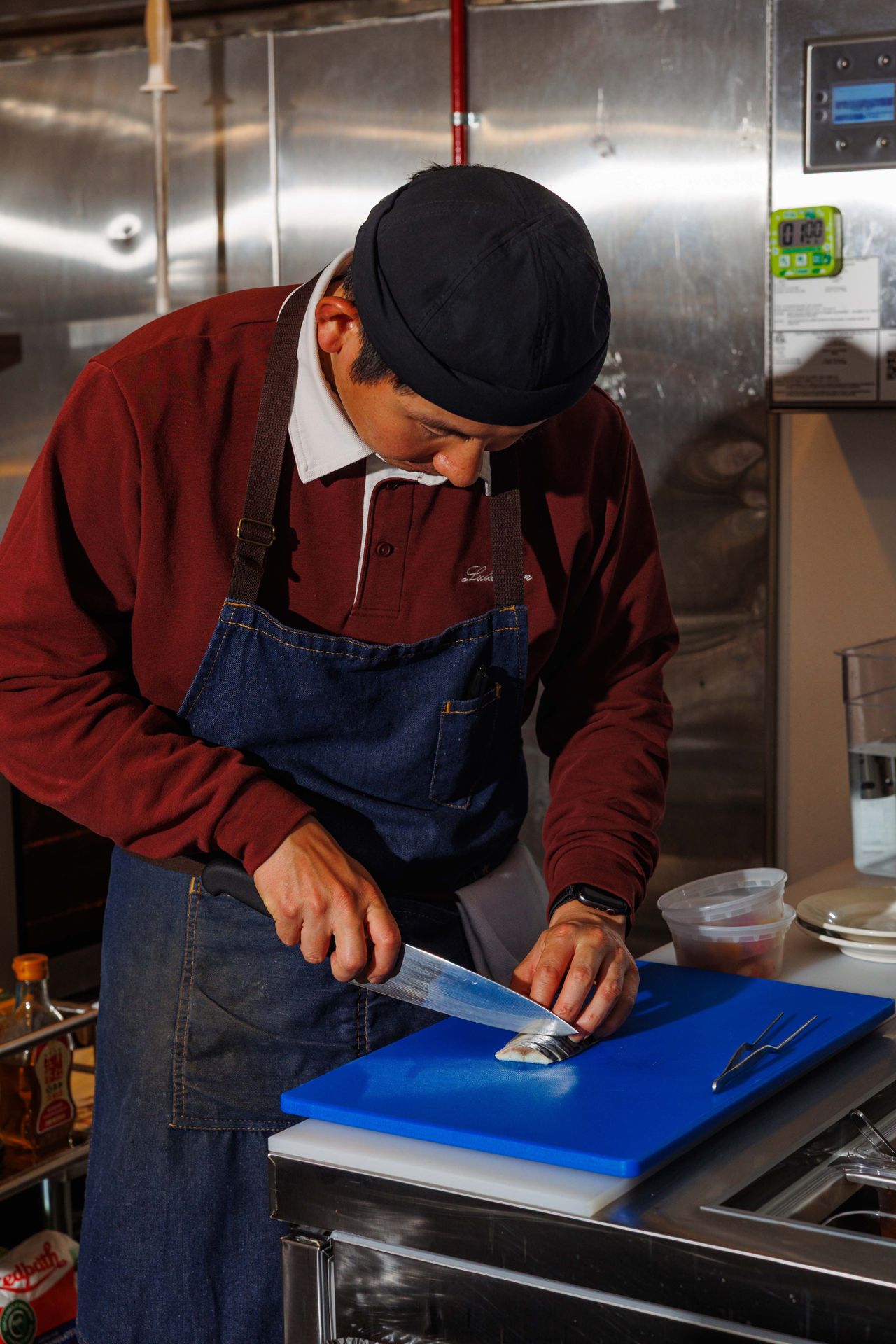A chef slices mackerel