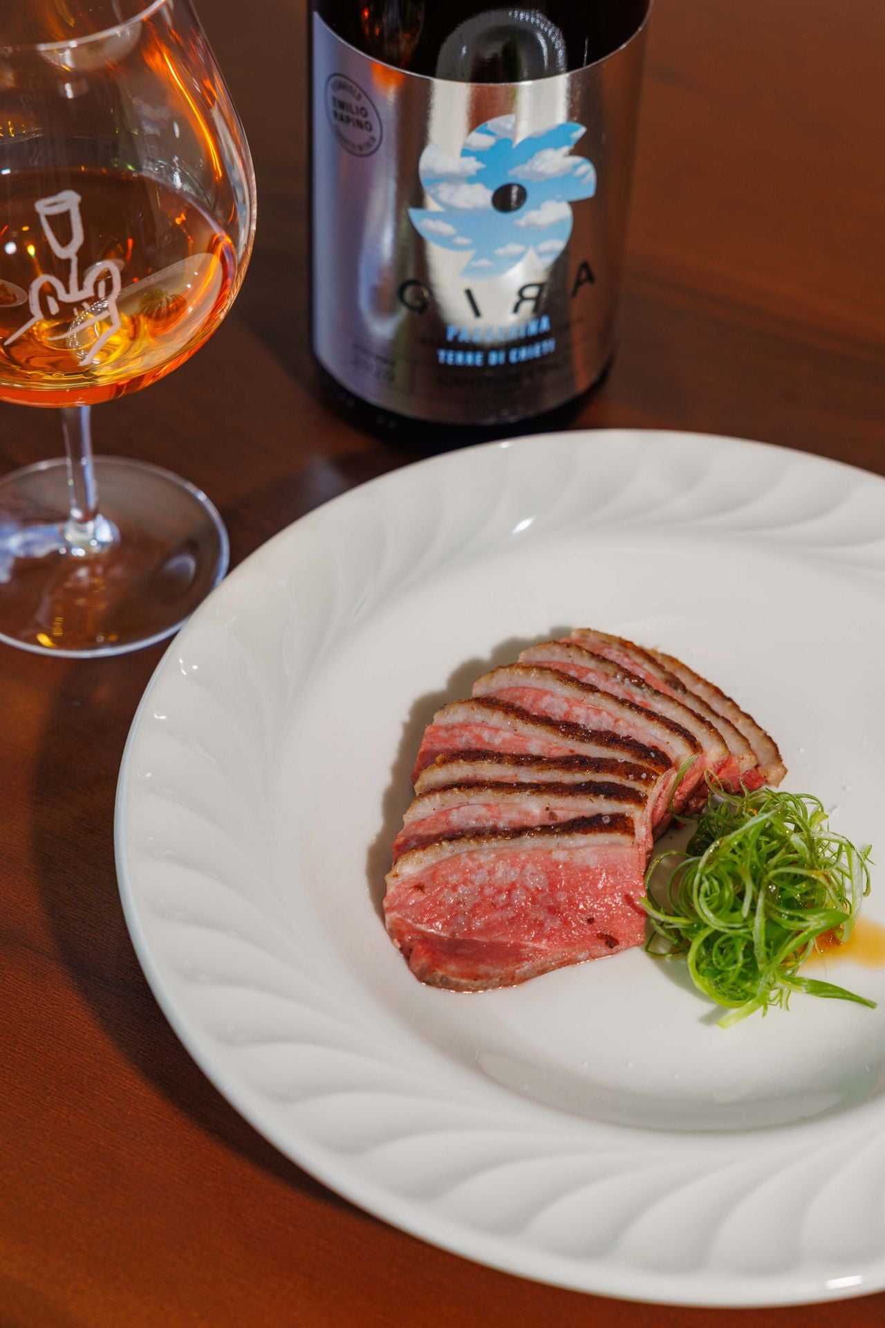 The Zhangcha duck breast from Stouffville is dry-aged for 48 hours with Sichuan pepper and orange peel, then cooked sous vide for two hours before being seared and smoked to order over a blend of Chinese black tea and applewood