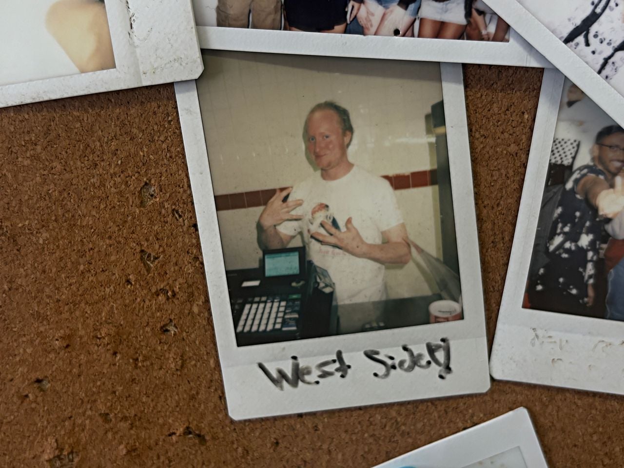 A Polaroid of Adam Ryan on a cork board at Cora's Pizza