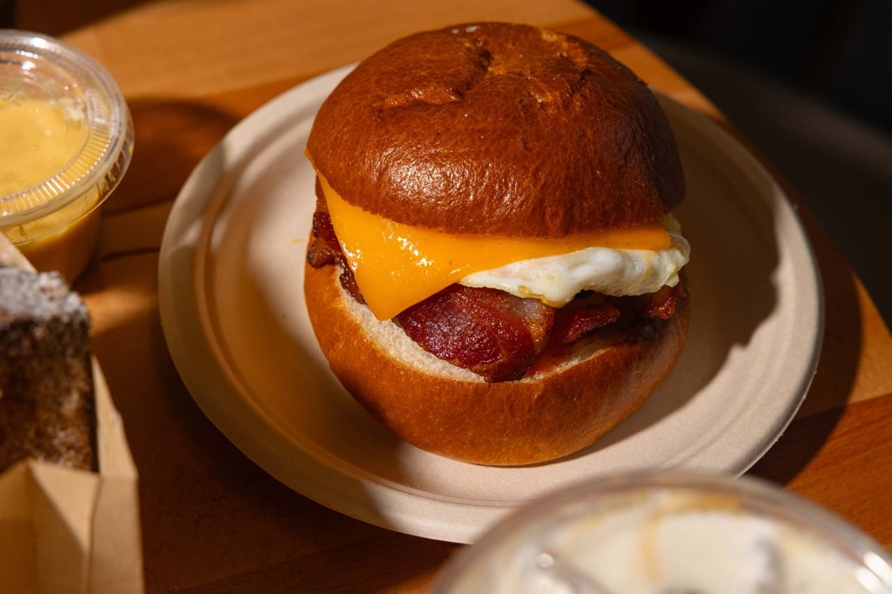 A textbook breakfast sandwich with a sunny-side up egg, cheddar, hardwood-smoked bacon and a swipe of chipotle-ketchup