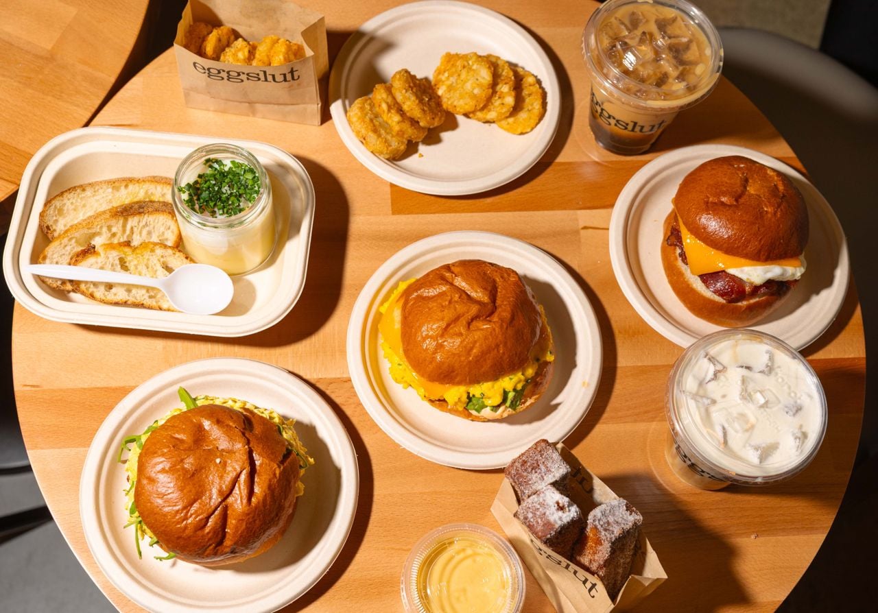 A spread of breakfast sandwiches, drinks and sides available at Eggslut