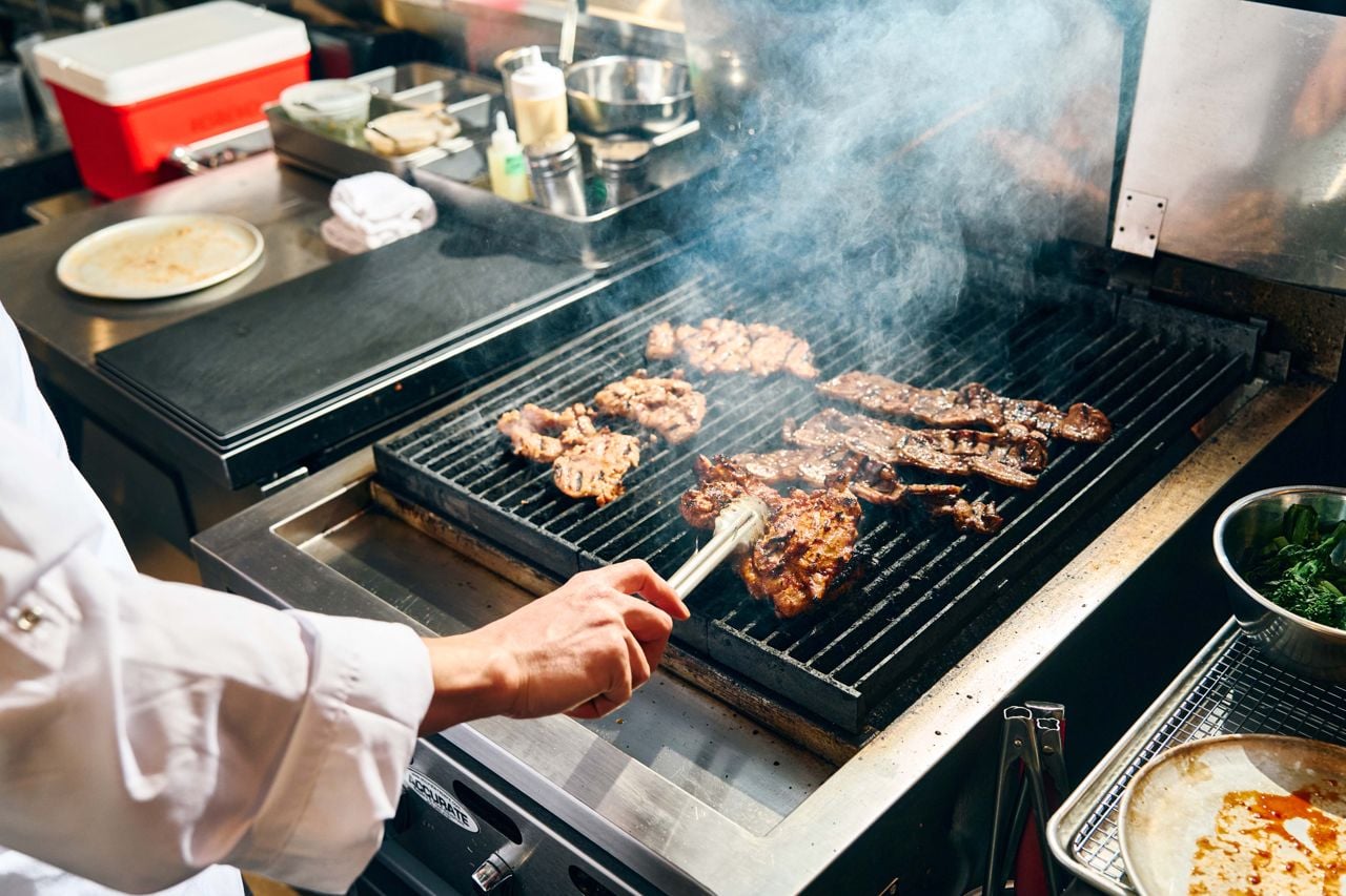 A chef grills Korean-style ribs