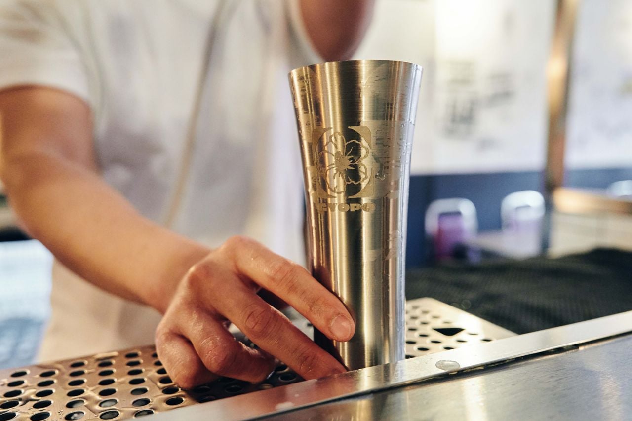 A metal cup of makgeolli