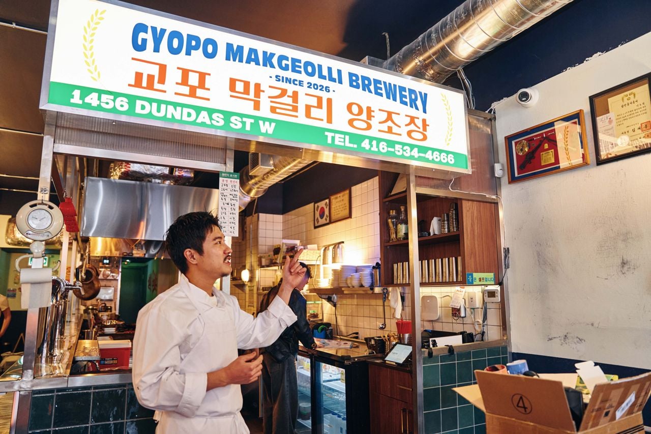 The chef at Gyopo Brewery points at framed certificates hanging on the walls