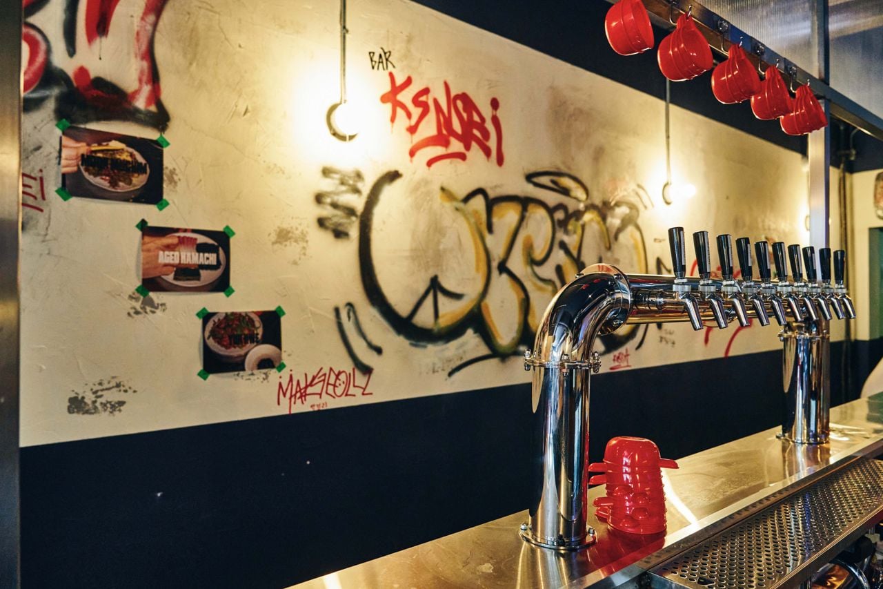 Makgeolli taps and graffiti art on the walls inside Gyopo Brewery