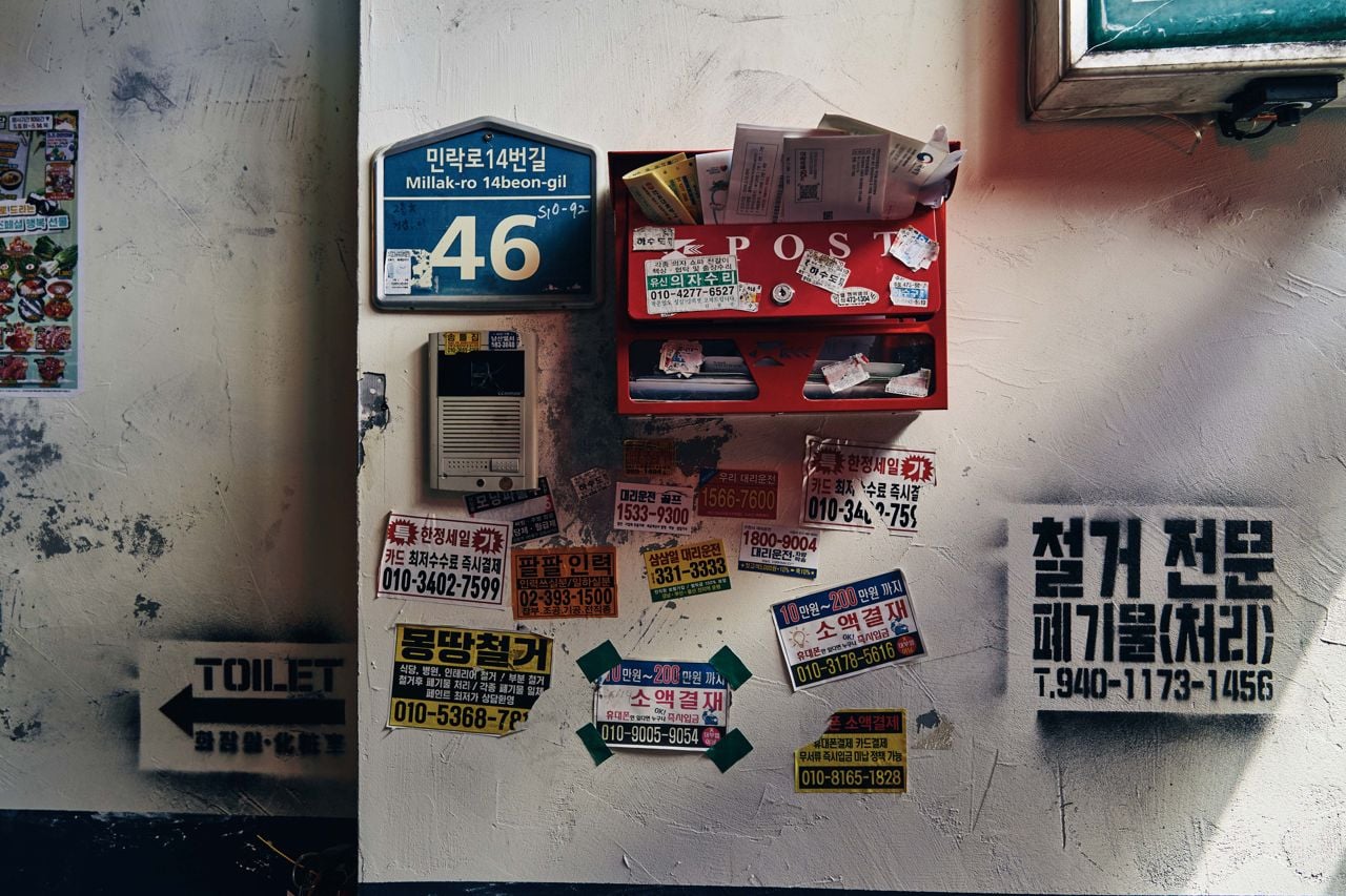 Korean stickers and signs on the walls inside Gyopo Brewery