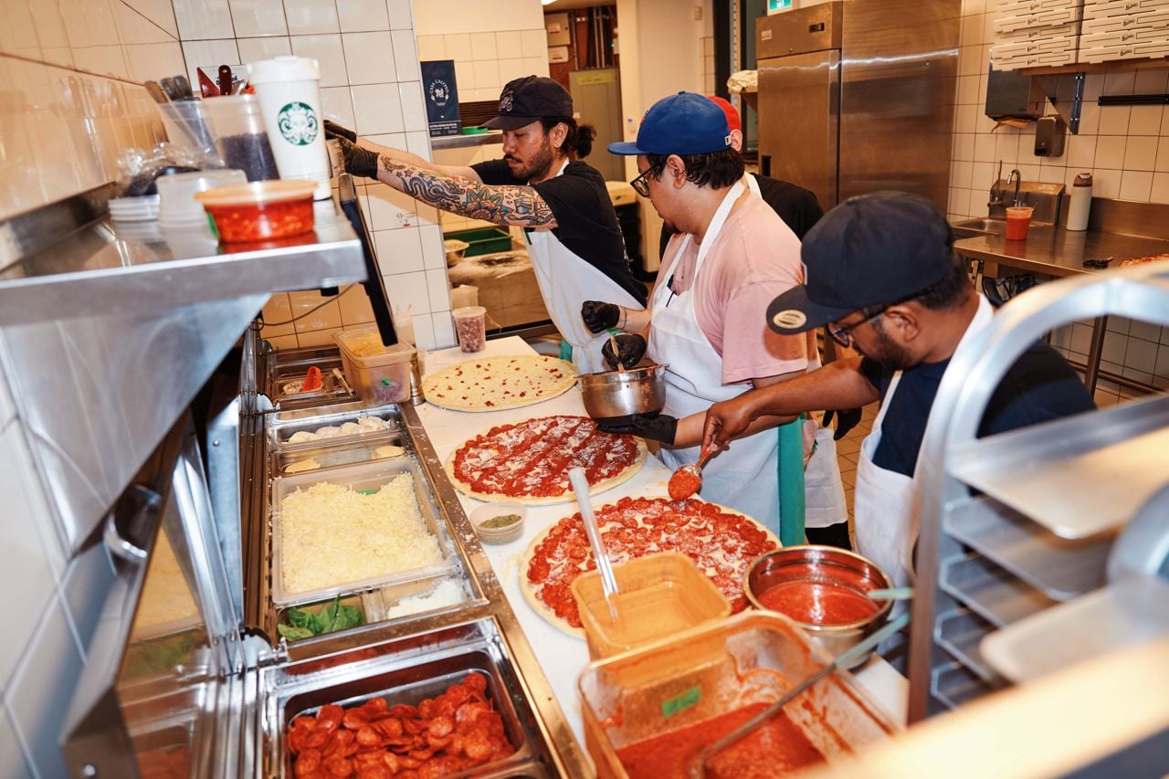 Cooks prep pizzas at Pizzeria Badiali