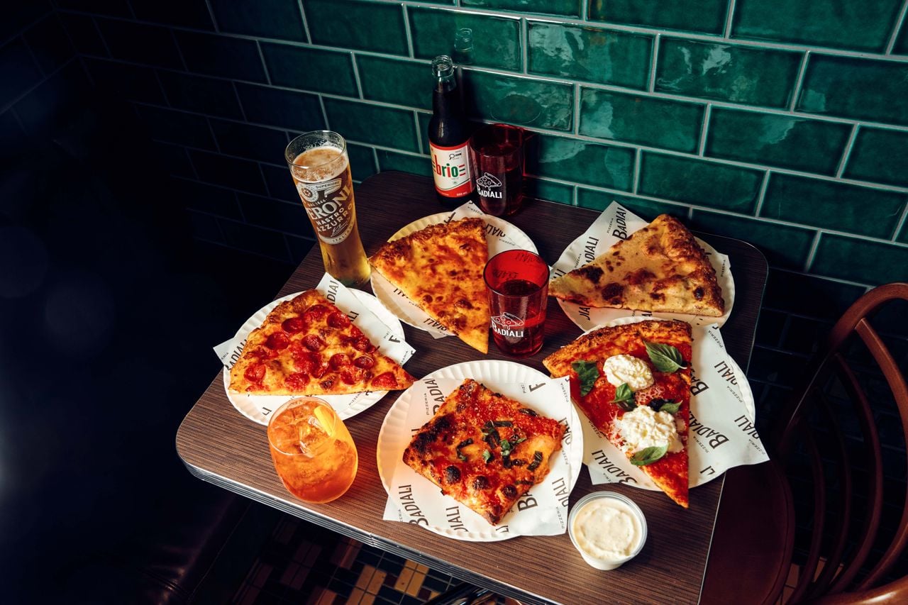 A selection of slices and drinks at Pizzeria Badiali's Mirvish Village location