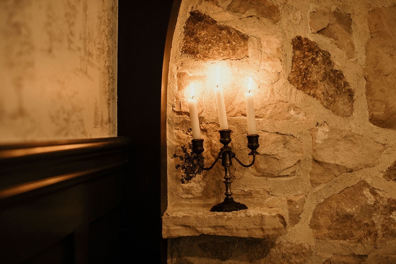 Candelabra in front of a stone wall