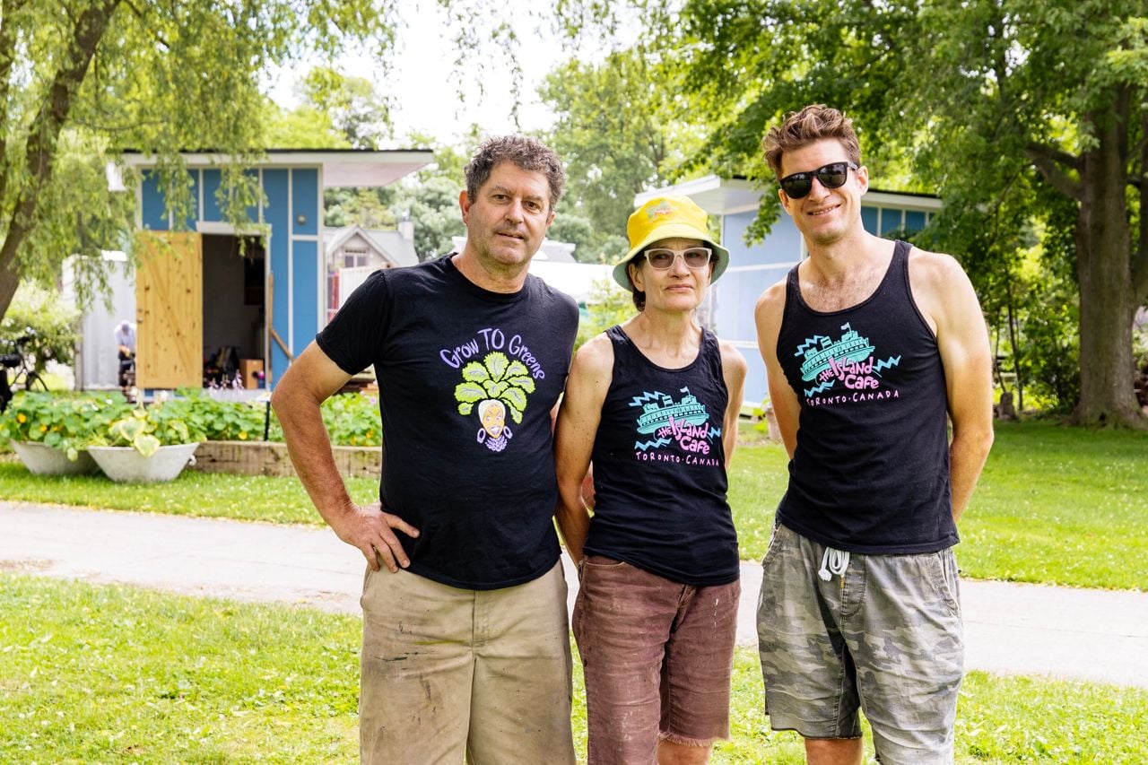 Zorah standing with his parents in Island Cafe merch