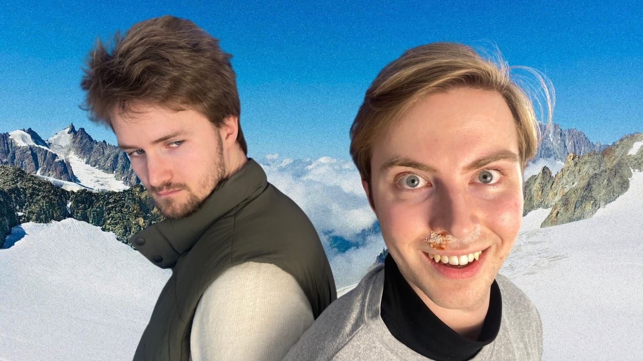 Two men standing back to back in front of a mountainous backdrop, one with white powder under his nose