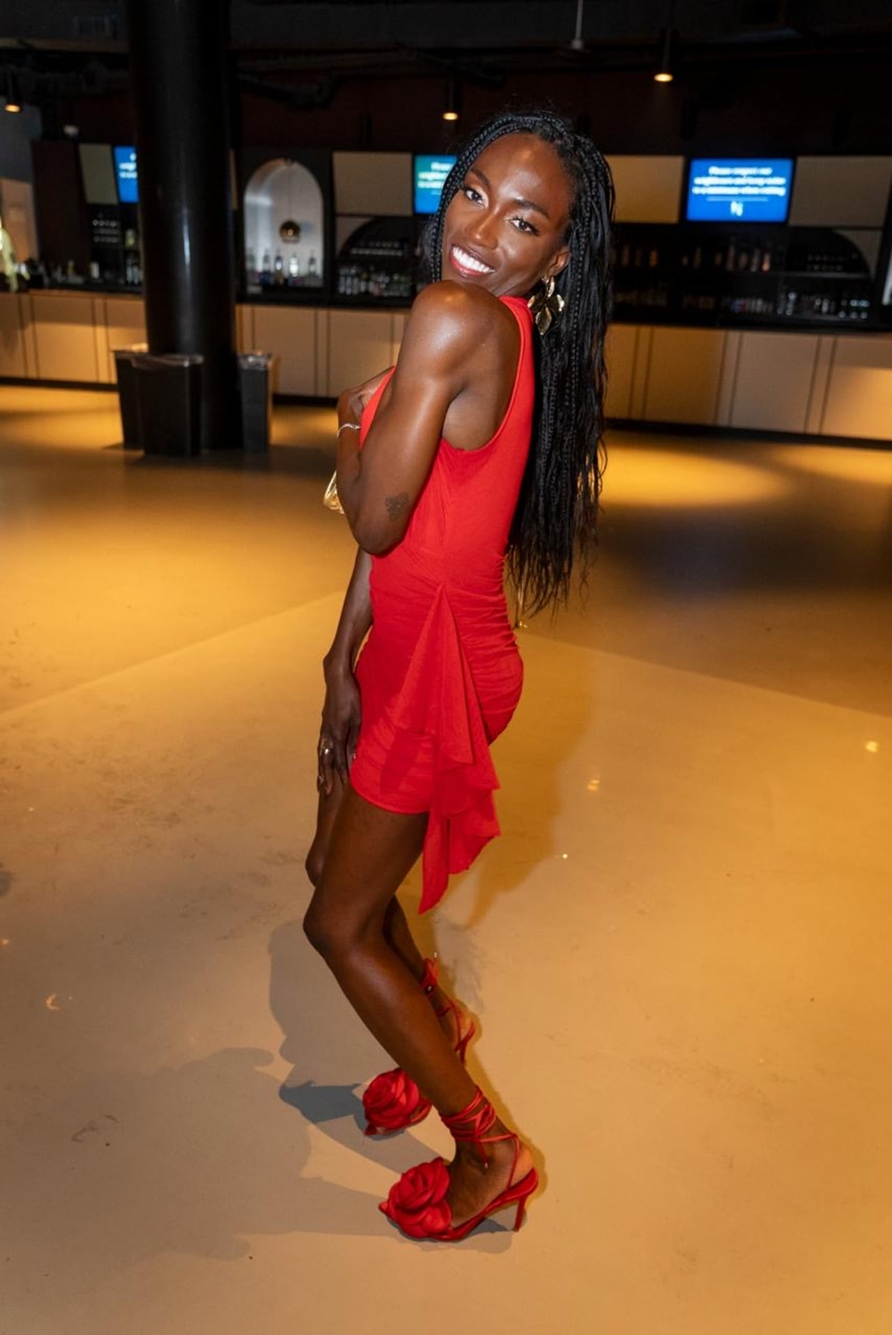 A performer in a red dress and heels