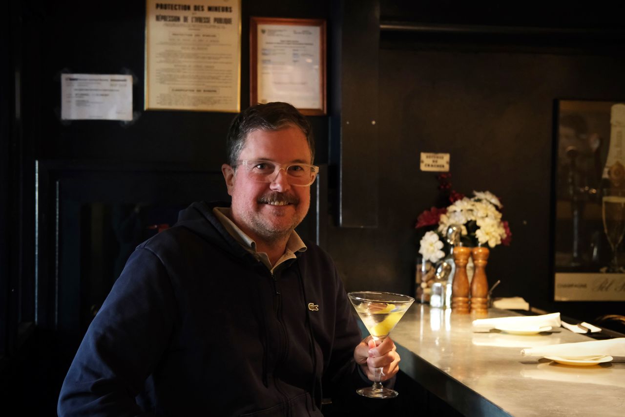 Lucas McCann sits at the bar at Le Paradis with a martini
