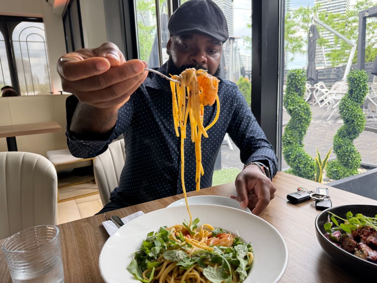 James Obazee holds up a forkful of pasta