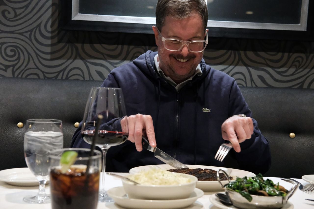 Lucas McCann cuts into a steak at Morton's