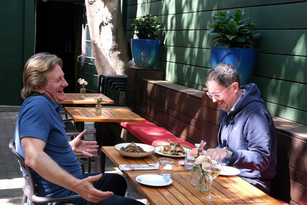 Andrew Carter and Lucas McCann sit on the patio at the Oxley