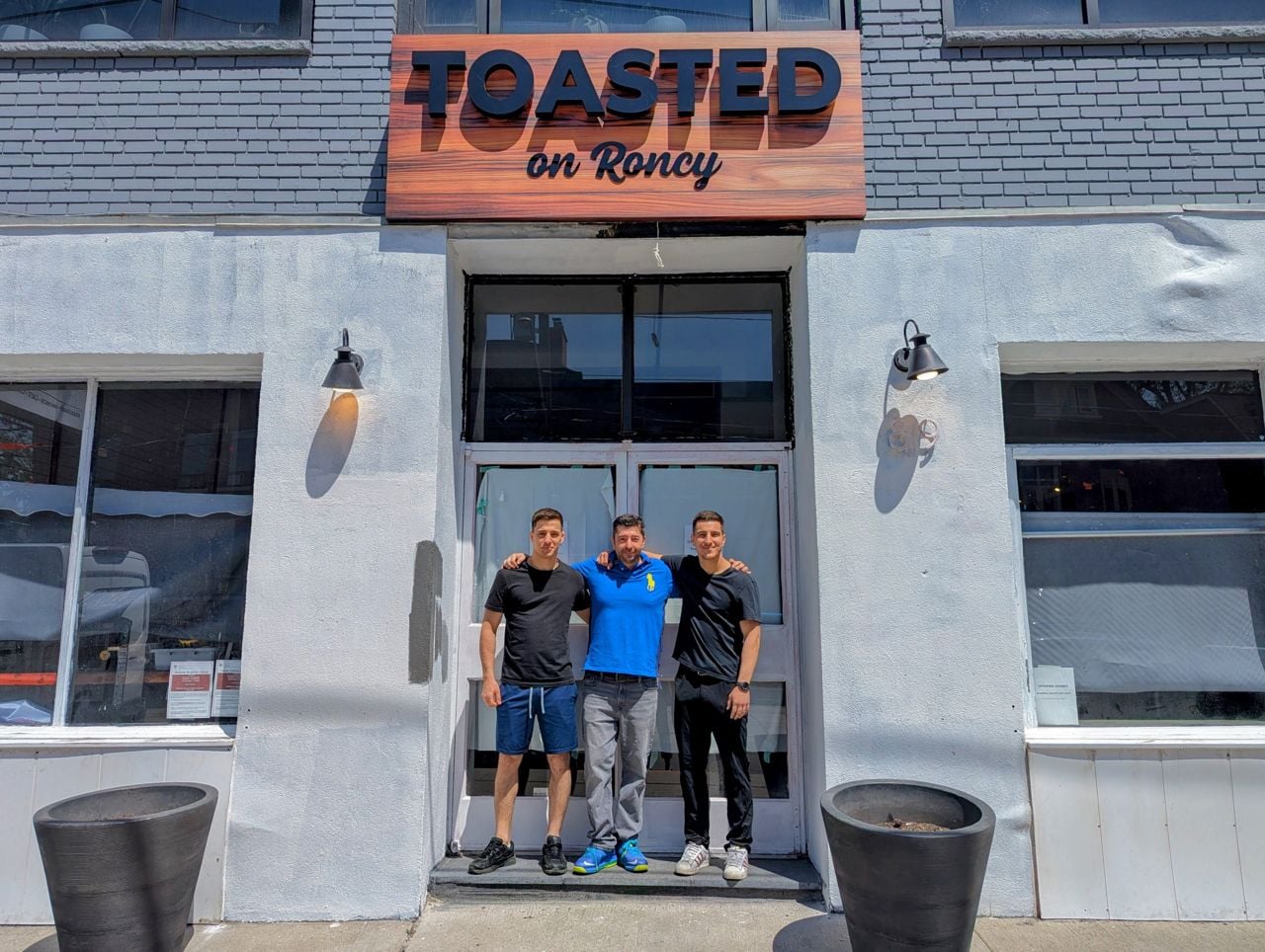 Angelo Ntouman, Jonn Poulakos and Andy Ntoumani outside of Toasted, their breakfast restaurant on Roncesvalles