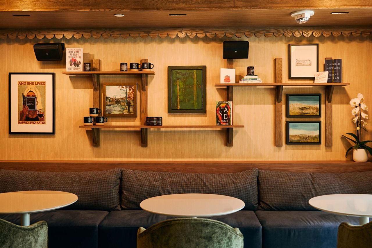 Comfy couches and two-top tables inside Book Bar