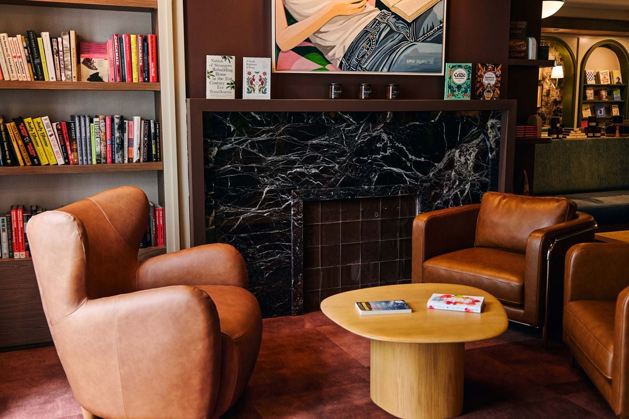 A sitting area by a fireplace on the main level of Book Bar