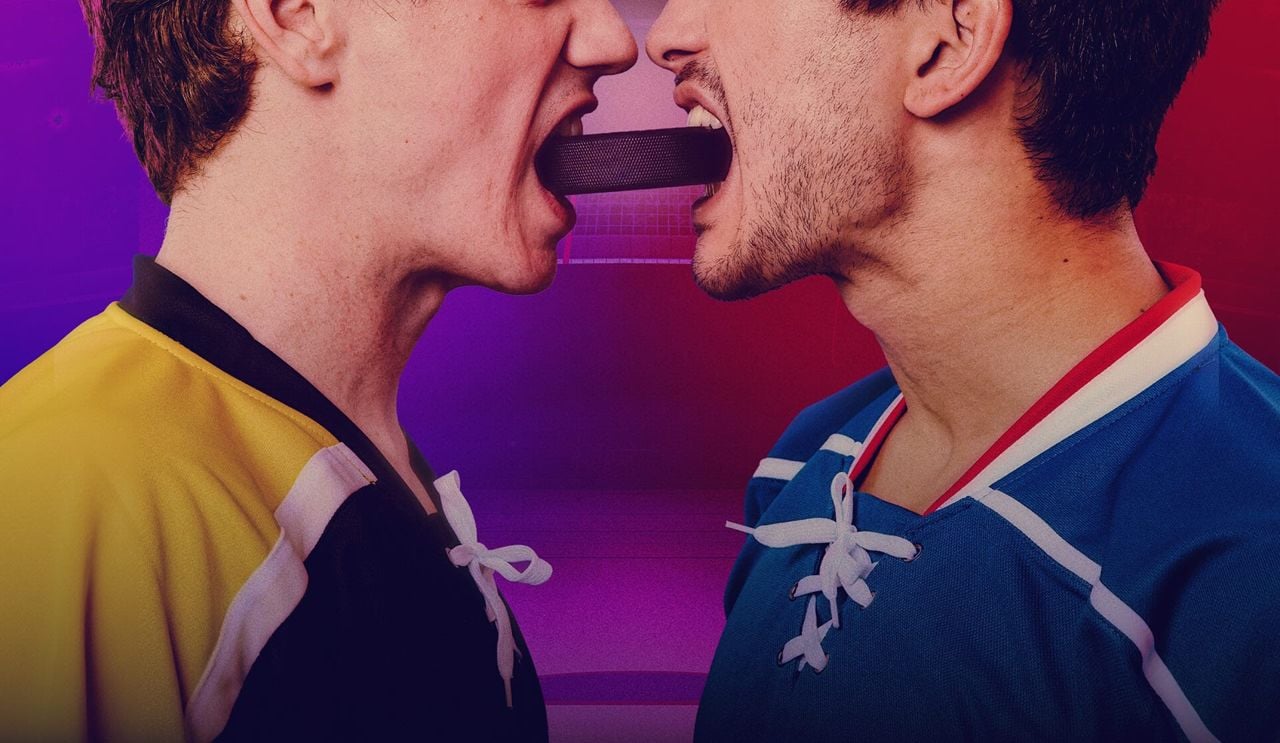 Lower half of two men's faces biting either end of a hockey stick
