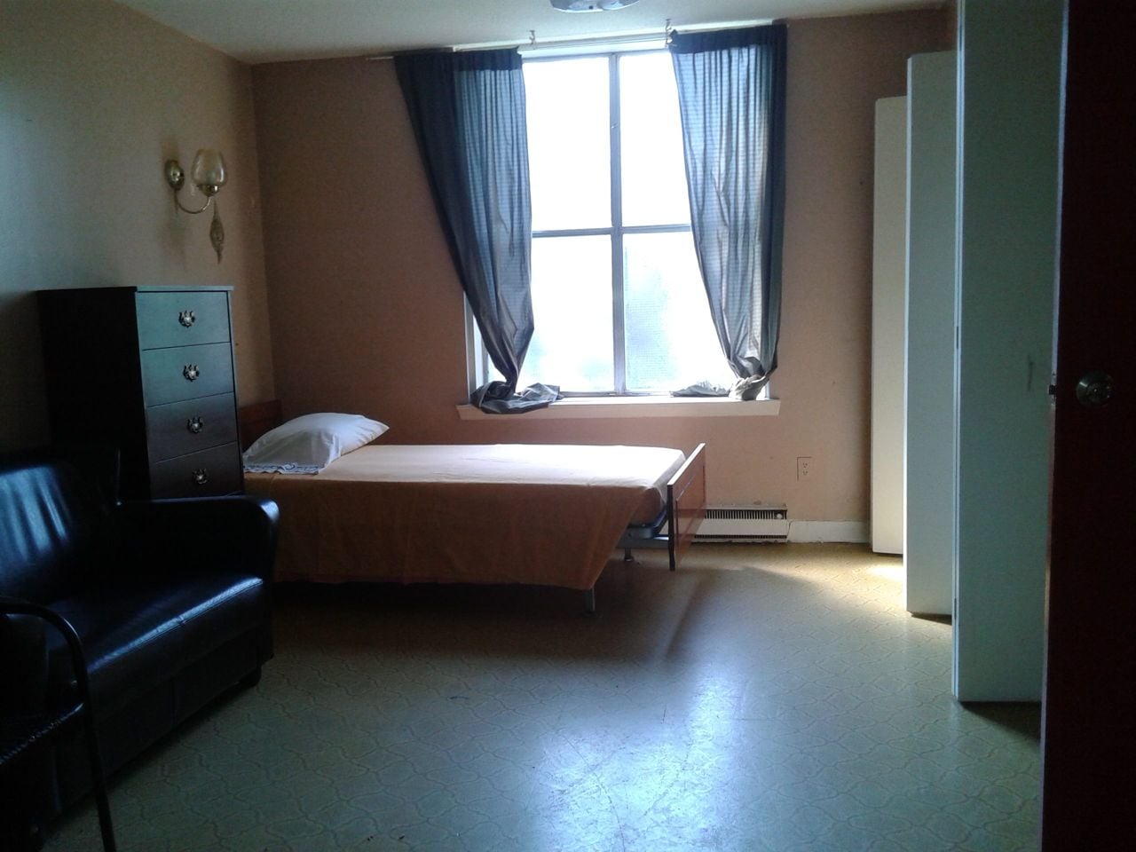 Single bed in a sparse room