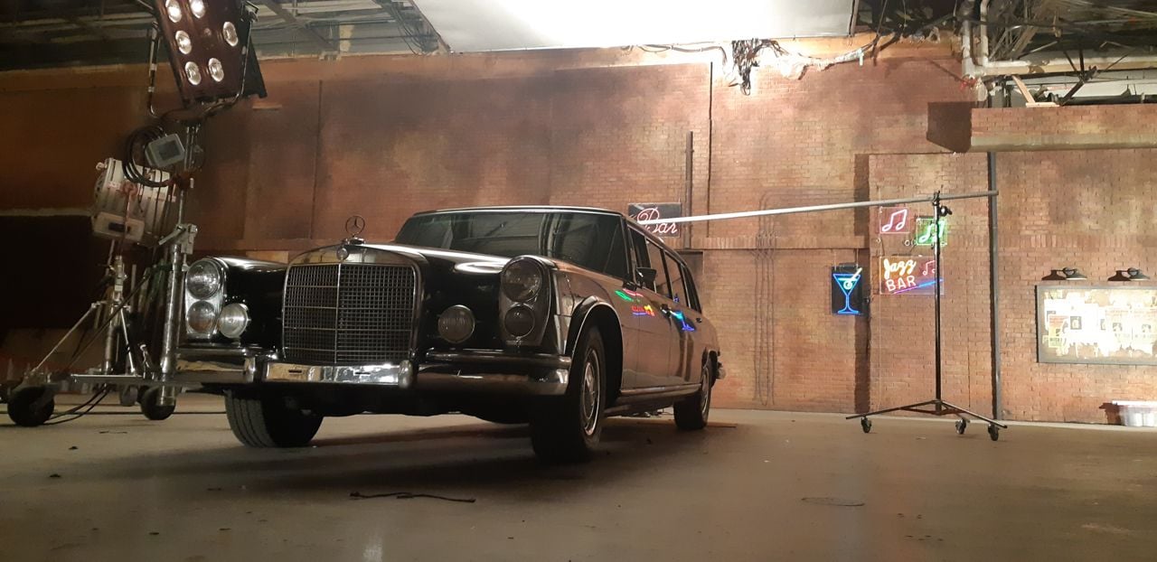 Vintage car in front of a brick wall