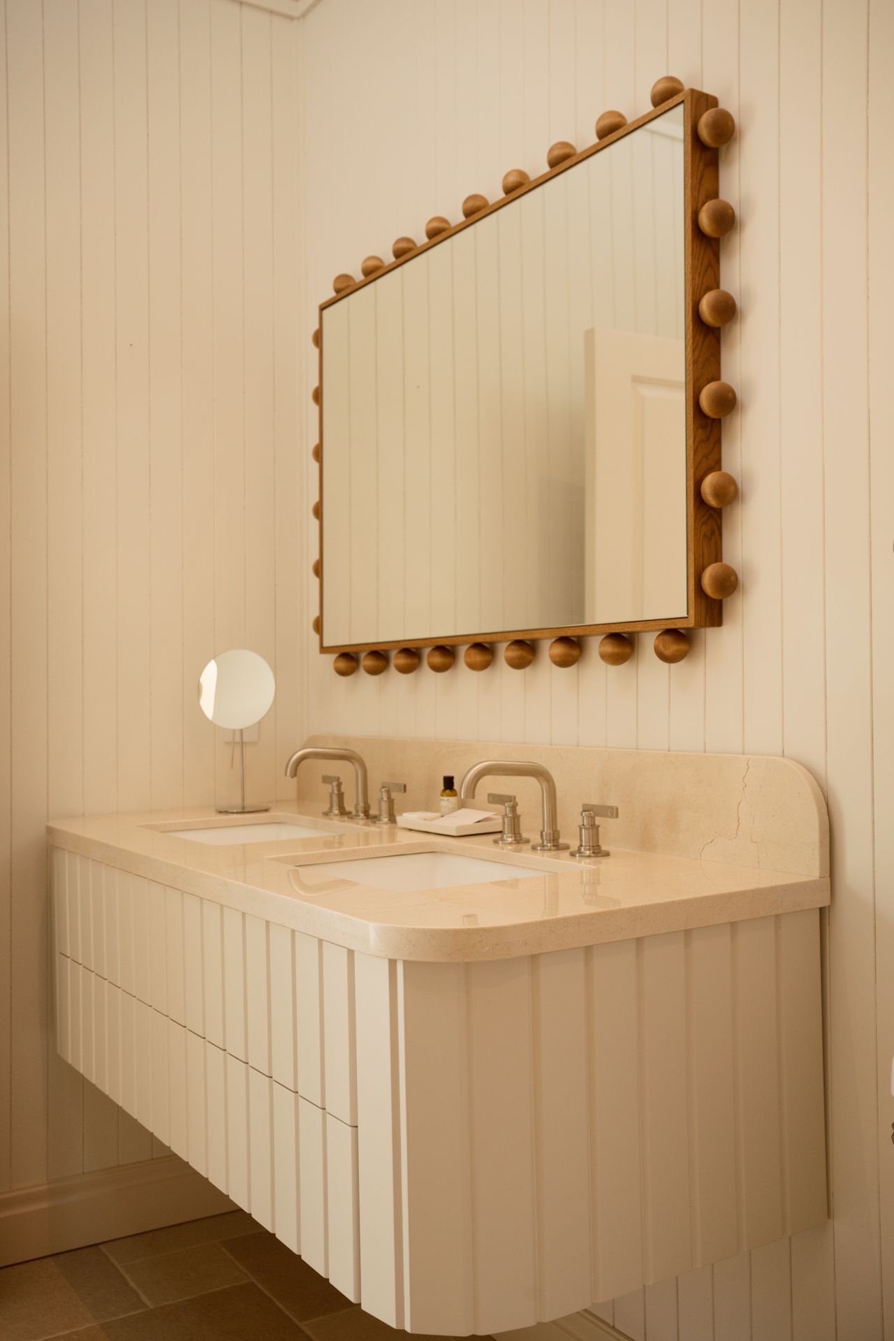 Funky mirror in a white bathroom