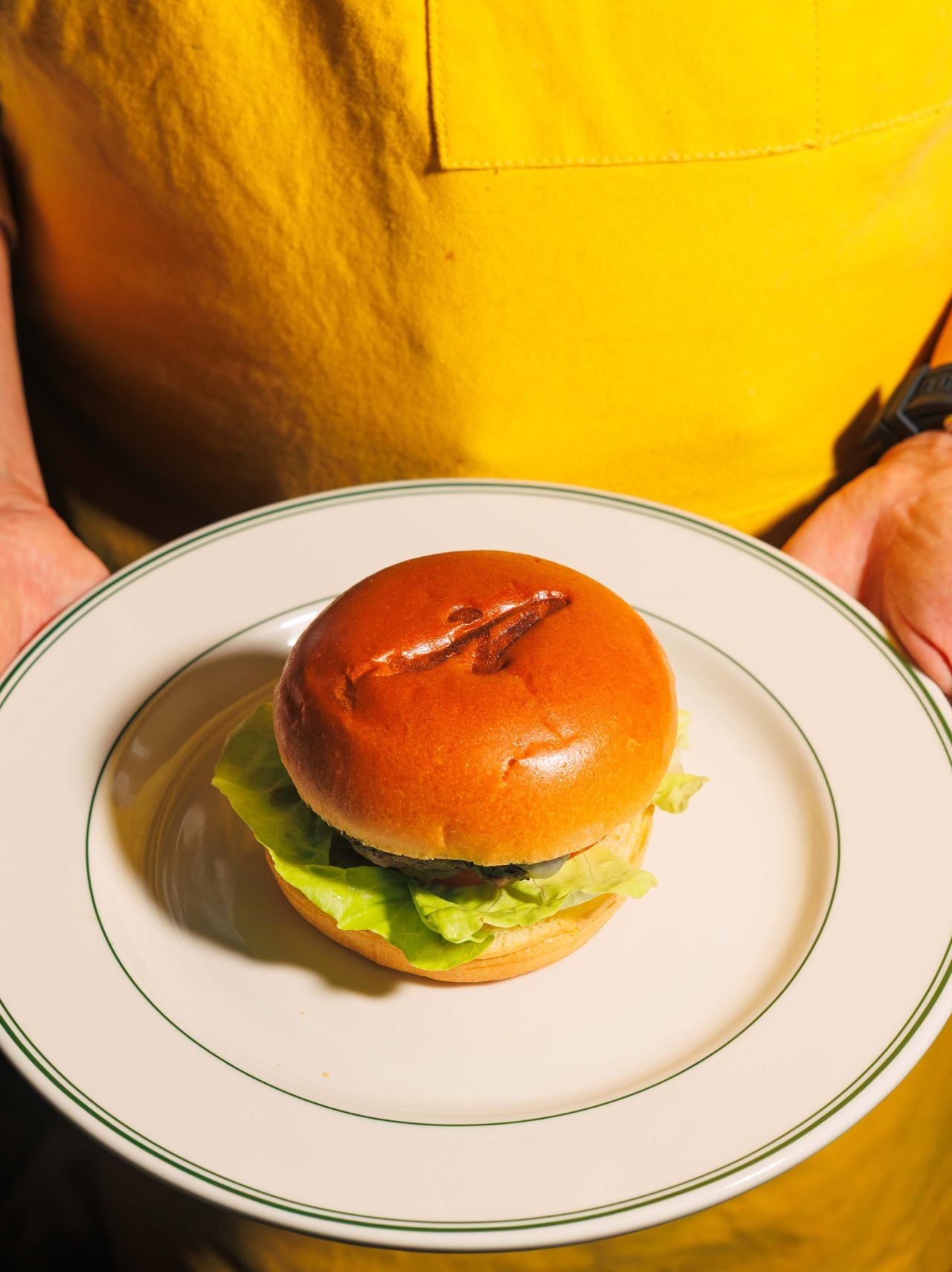 The signature smash burger is a double Oklahoma-style patty cooked with shaved sweet onion, topped with aged cheddar and Archie’s secret sauce, and served on a classic brioche bun that’s branded with an “A” for Archie