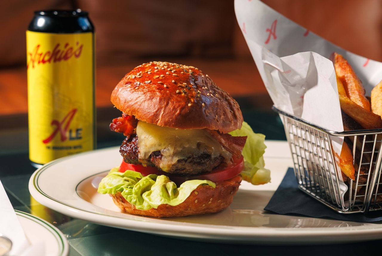 The Southern Smokehouse burger, topped with bourbon-marinated caramelized onions, smoked provolone and ancho pepper–infused chipotle aïoli inside a pillowy, sesame brioche bun.