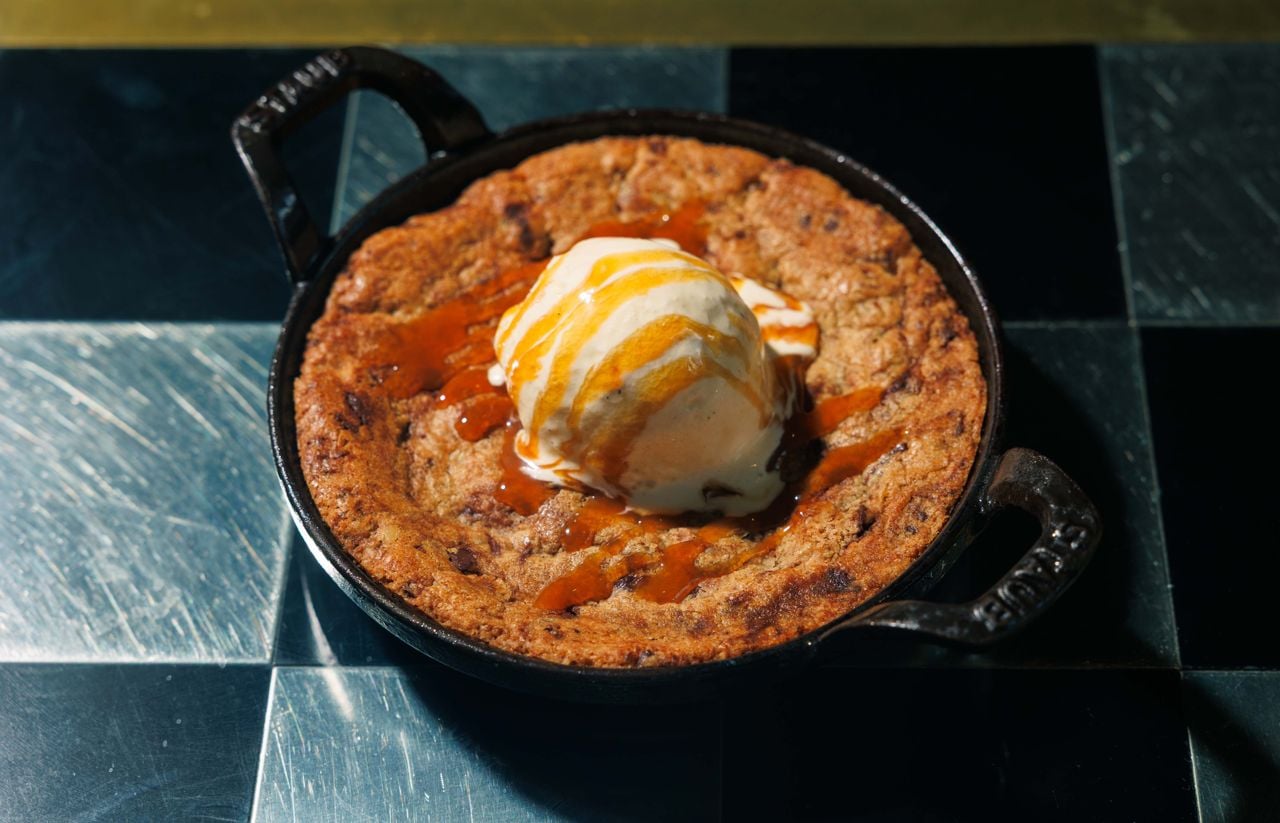This chewy-soft, pan-sized cookie arrives in the cast-iron skillet it was baked in, topped with a scoop of vanilla ice cream and a hefty drizzle of bourbon caramel
