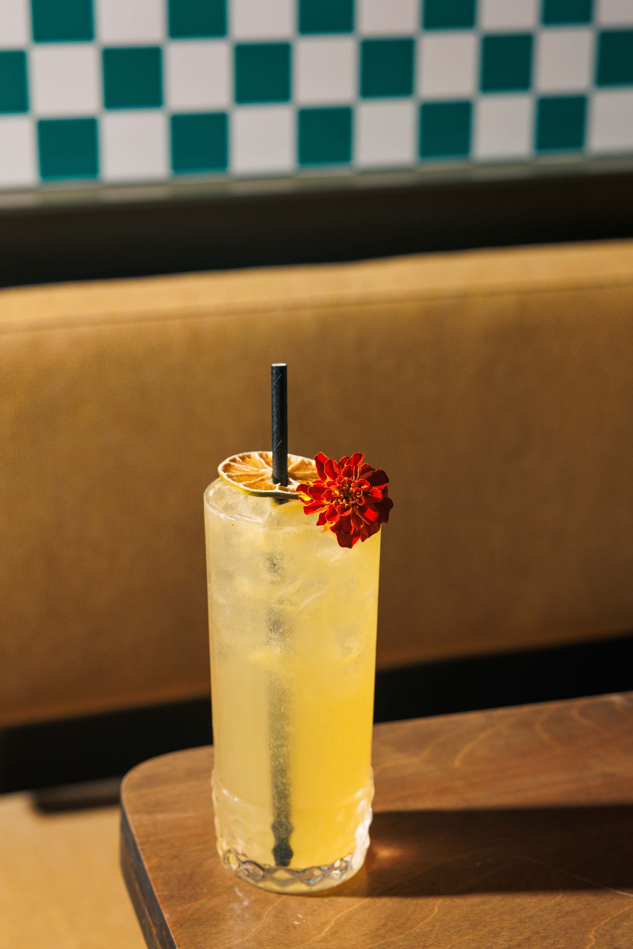 Pole Dancer is a boozy and sweet blend of overproof Ketel One vodka, overproof Jamaican rum, passionfruit purée, lime juice and ginger, with the straw poked through the middle of the citrus garnish