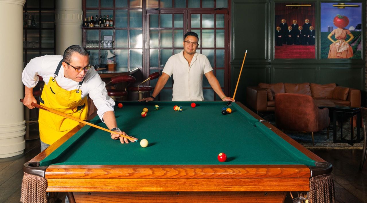 Two men play pool at Archie's in Toronto