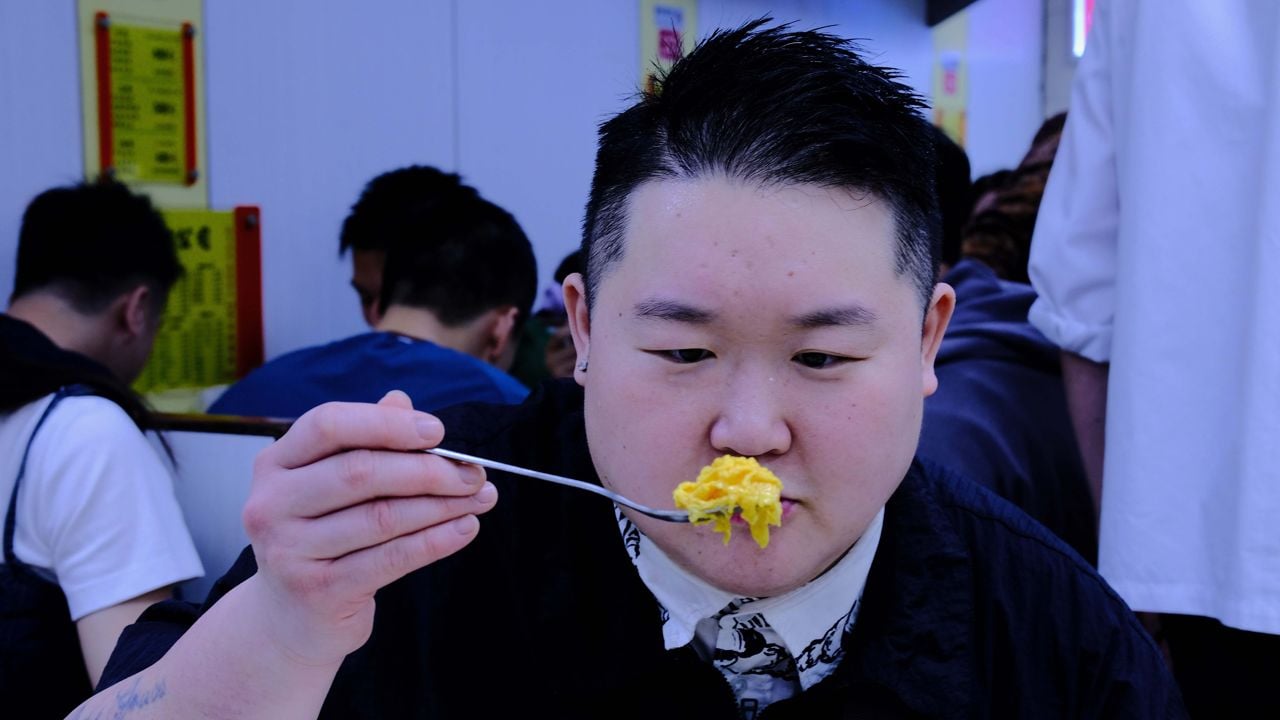 Chef Eva Chin holds up a spoonful of egg