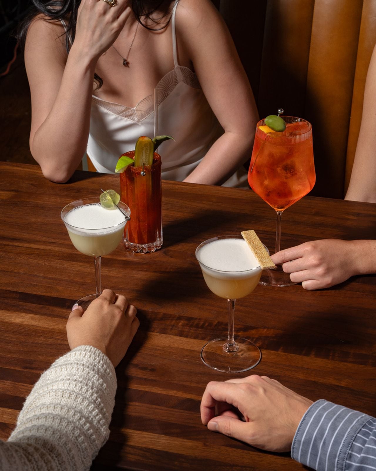 A table of people with cocktails