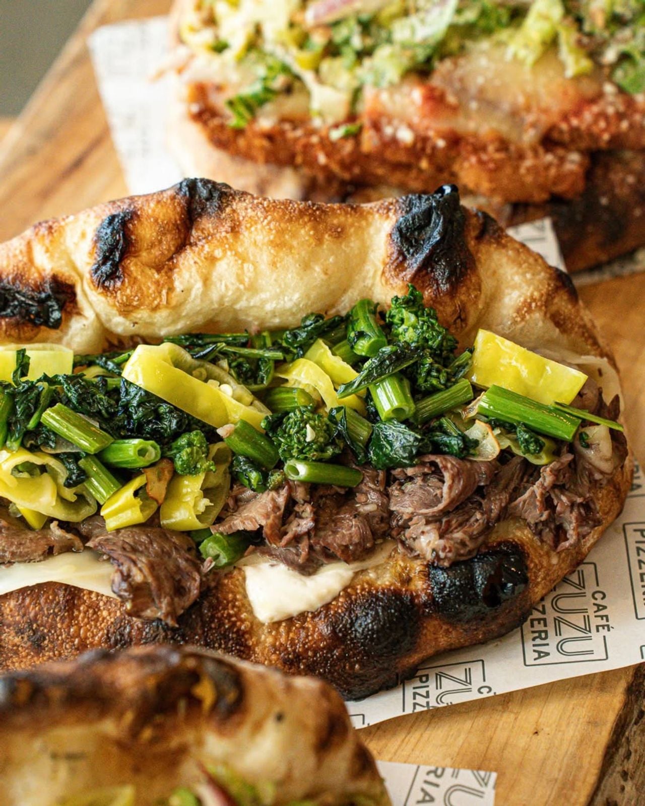 A closeup of a panuozzo at Cafe Zuzu Pizzeria in Toronto