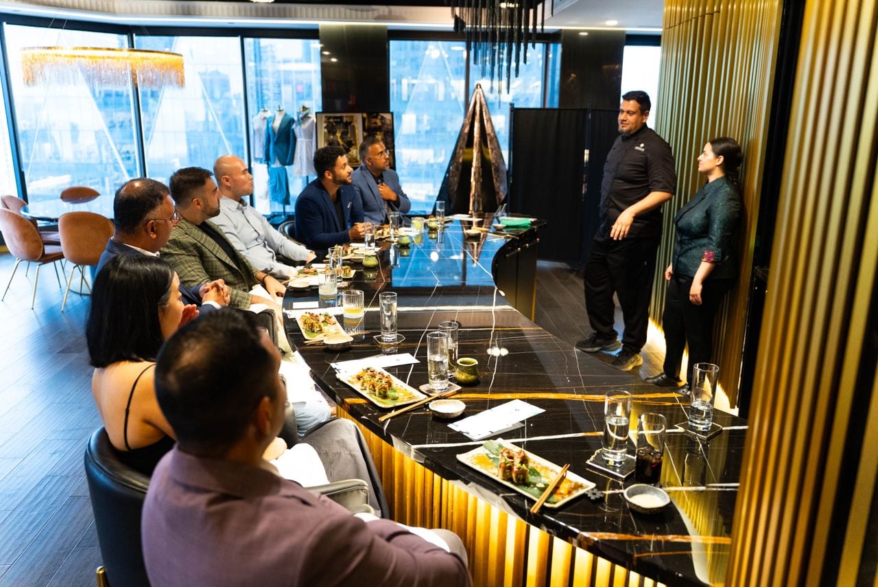 A group of seven diners experience an omakase dinner at King and Bay, a bespoke tailor