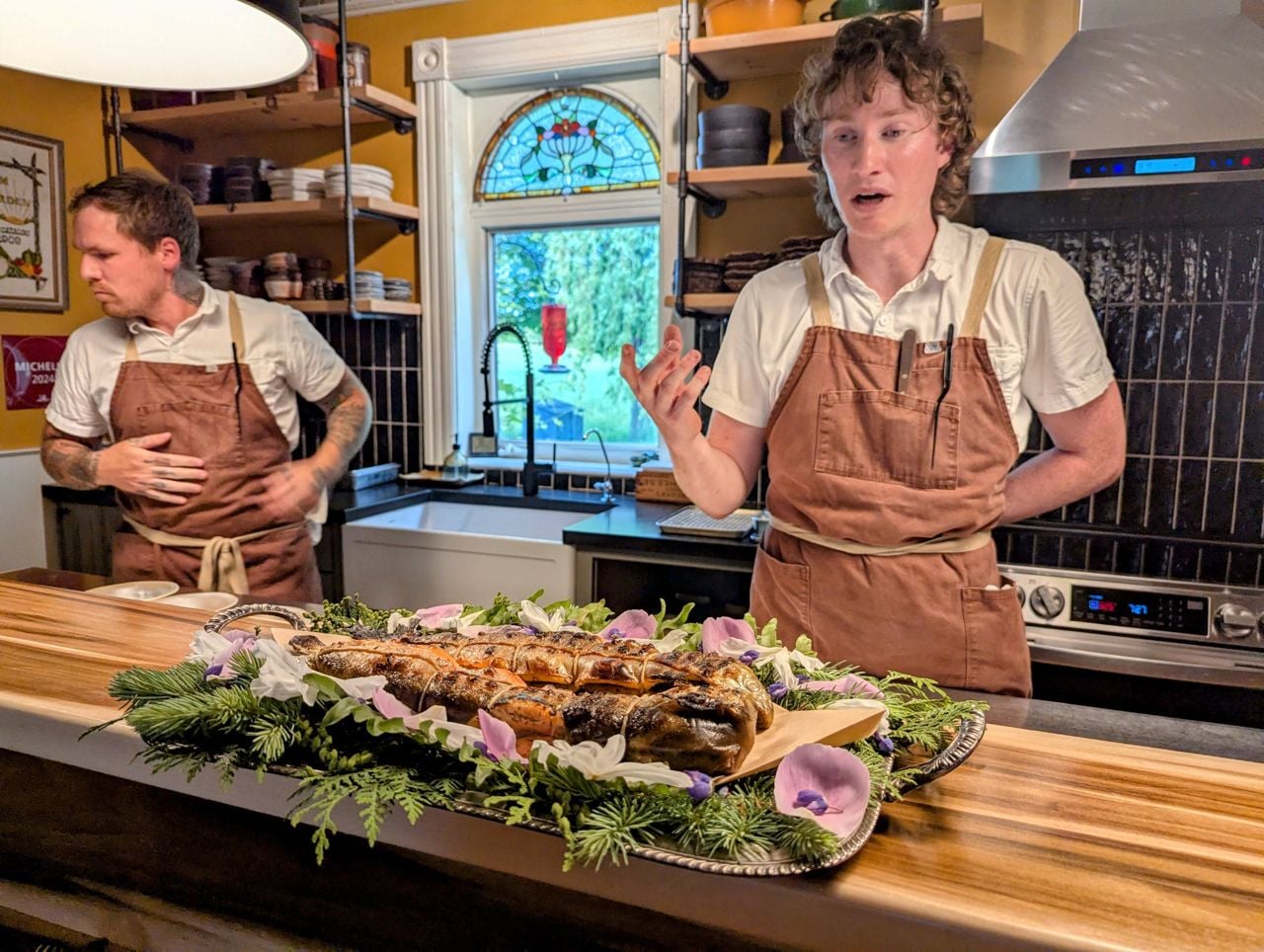 Chefs at Down Home Farmhouse Restaurant explain a fish dish