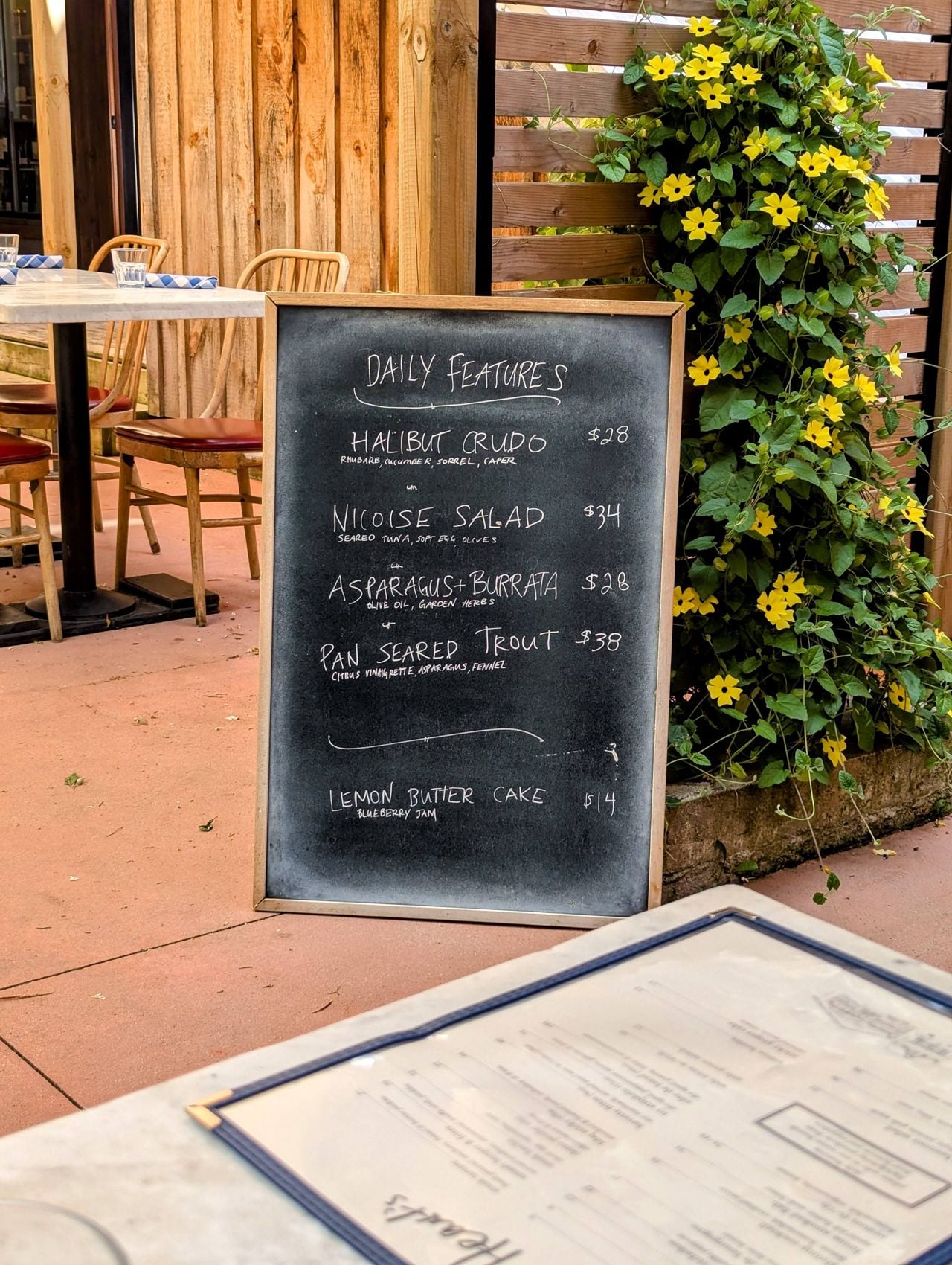 A chalkboard menu on the patio at Hearts Tavern