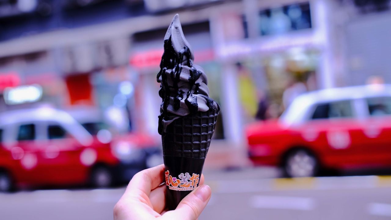 Black sesame paste soft serve ice cream in a cone