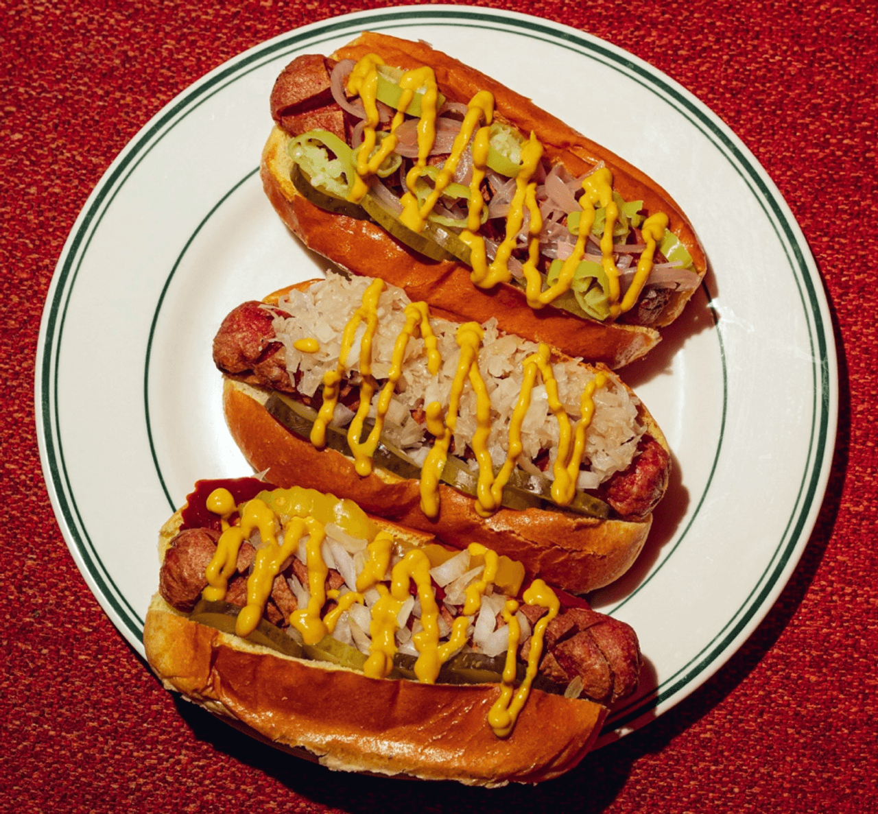 A plate of three hot dogs