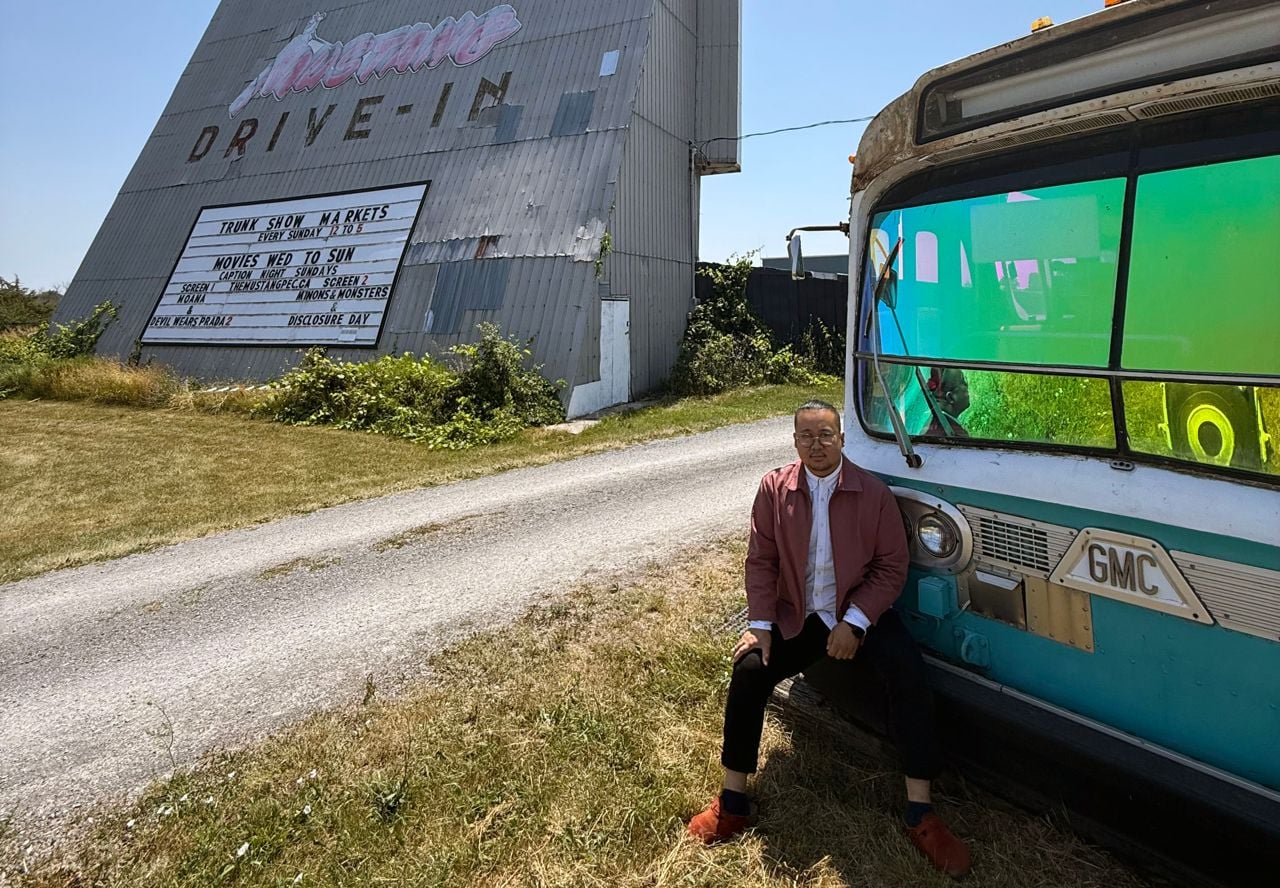 Justin Tse sits on the bus outside of the Mustang Drive-In