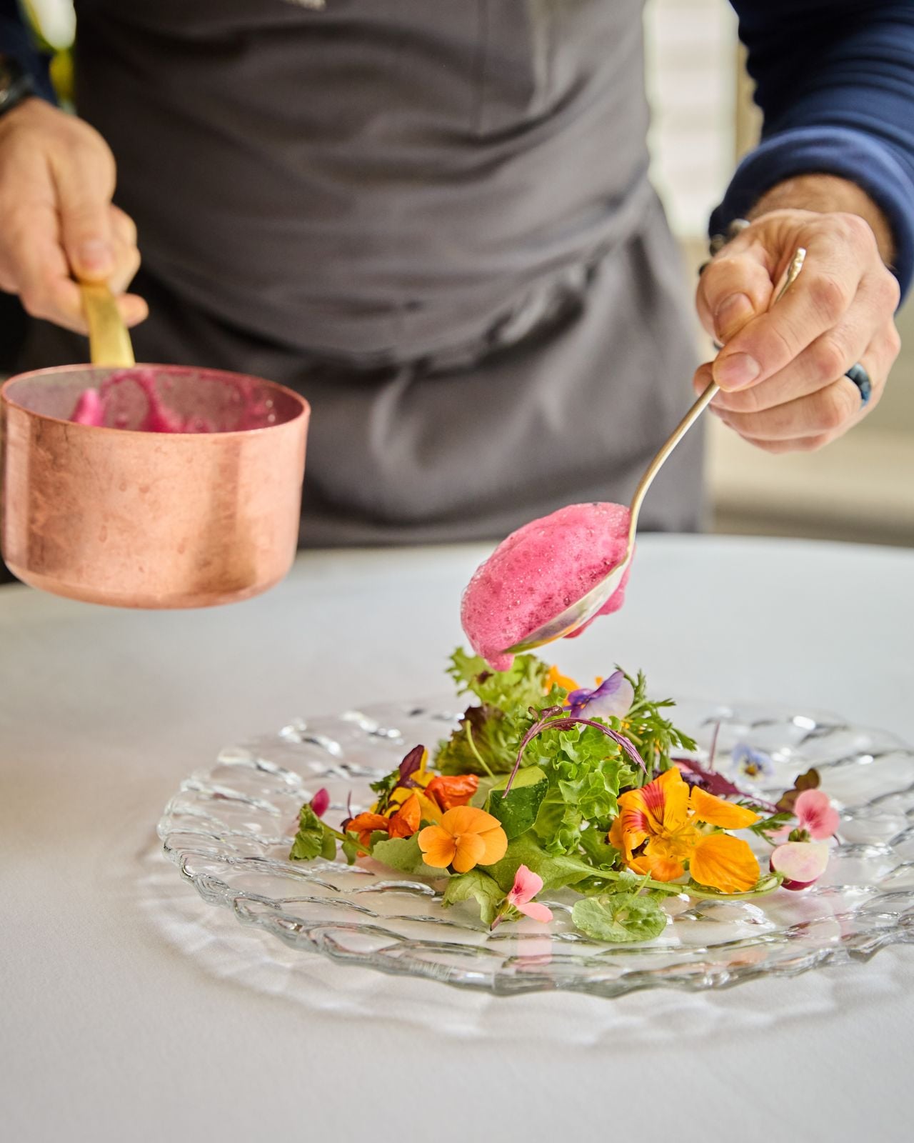 A chef plates a salad at Langdon Hall in Cambridge, Ontario