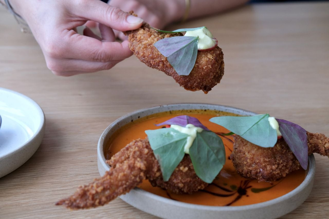 Here are the Wings à la Royale, stuffed with lobster and anointed with fermented chili beurre blanc, chili oil and chimichurri aïoli.