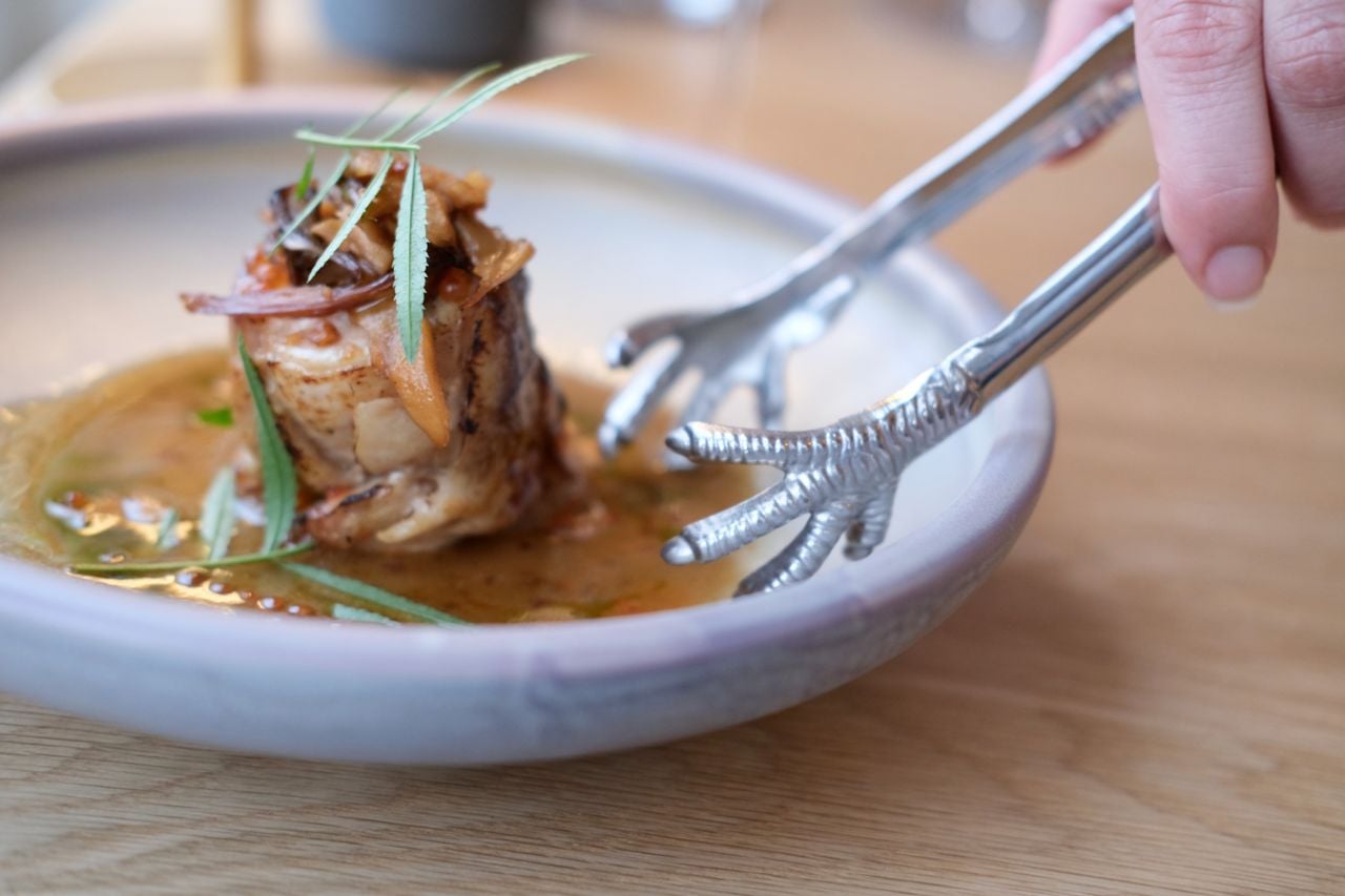 Meat from a heritage hen is rolled ballotine-style (combining white and dark meat), then roasted and topped with maitake and Hen-of-the-Woods mushrooms, pickled Tropea onions and tarragon oil