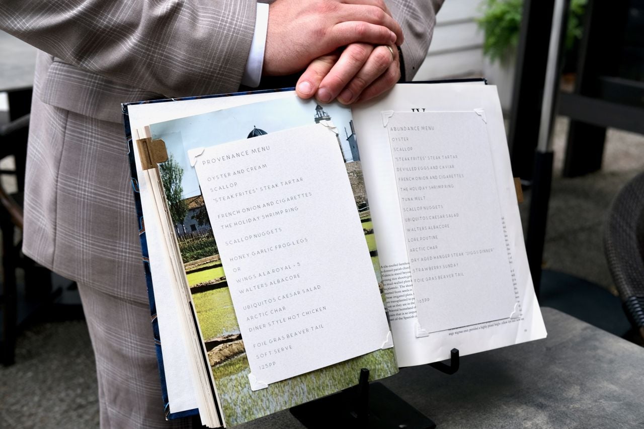 The menu at Lore Restaurant is pasted into an old cookbook