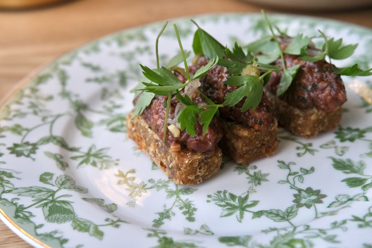 Steak frites, but make it tartare: hand-chopped Martin Family Farms’ hanger steak seasoned with leeks, lovage and dried shrimp vinaigrette is piled onto an haute hashbrown
