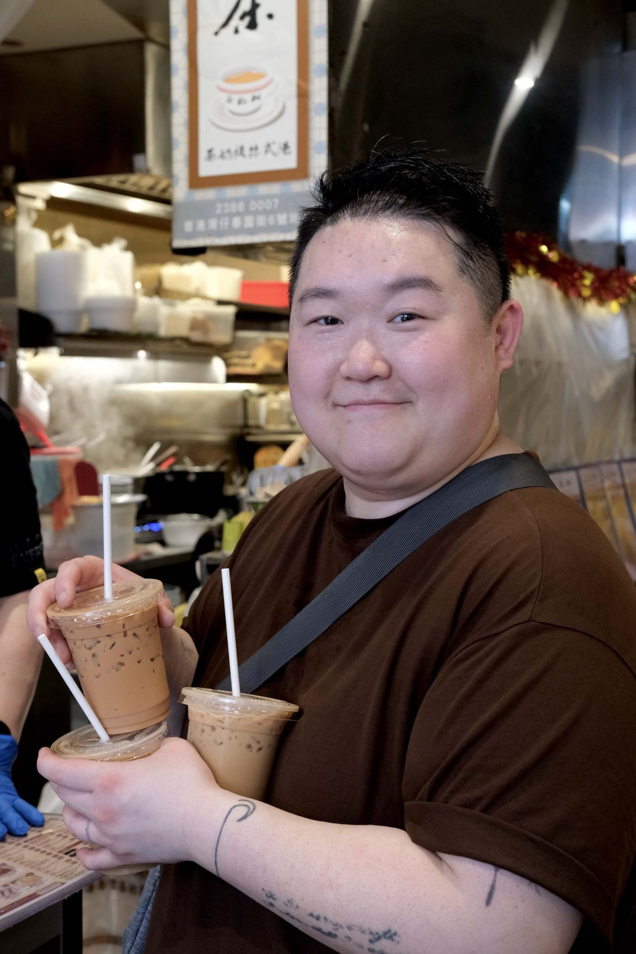 Chef Eva Chin holds cups of milk tea at a shop in Hong Kong
