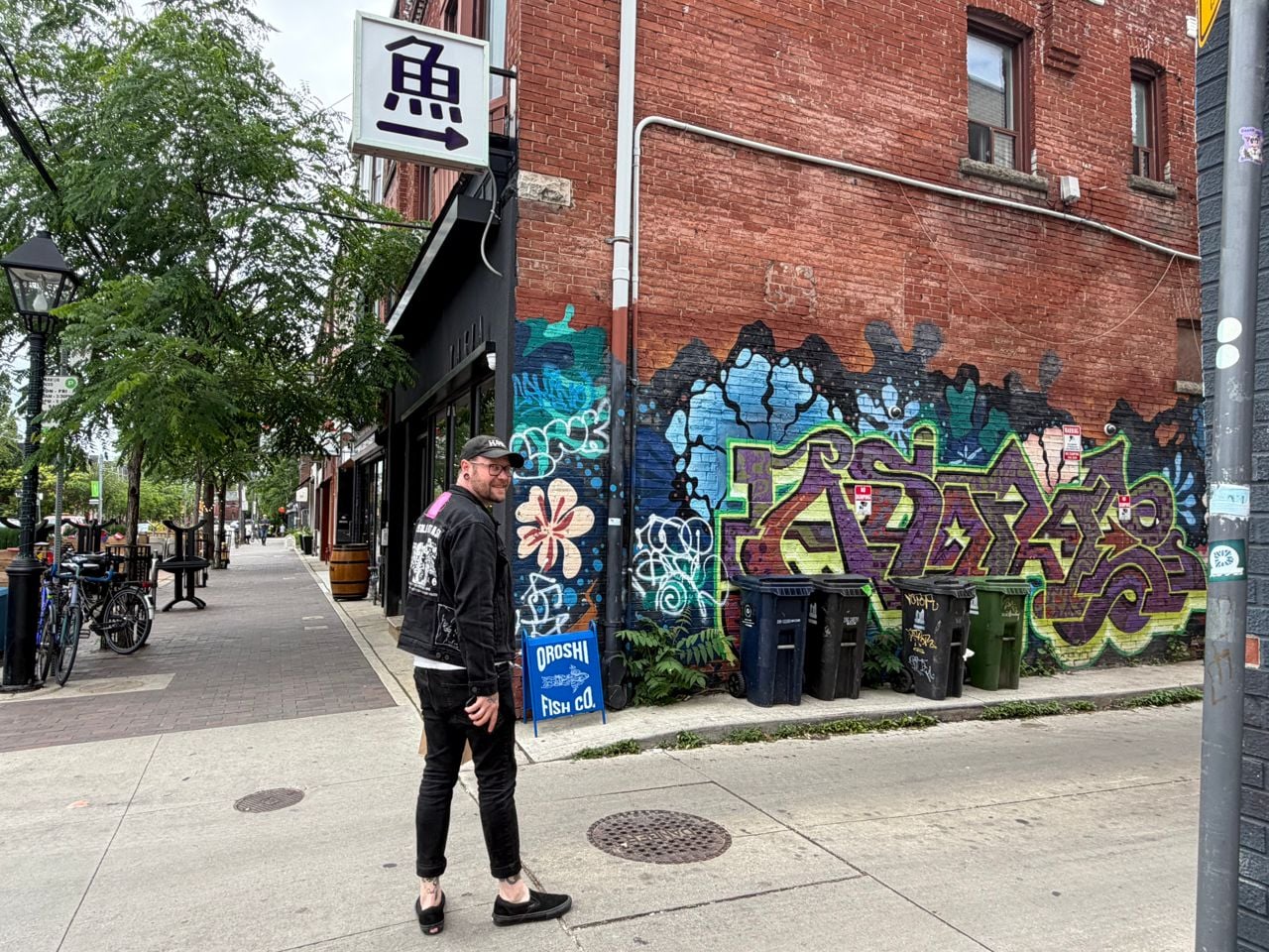 Chef Taylor McMeekin stands near a Dufferin Grove alleyway