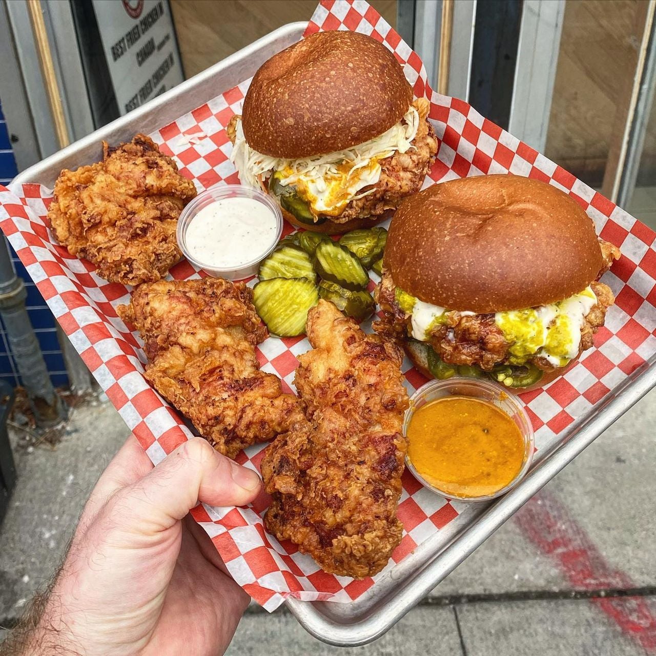A tray of fried chicken and fried chicken sandwiches