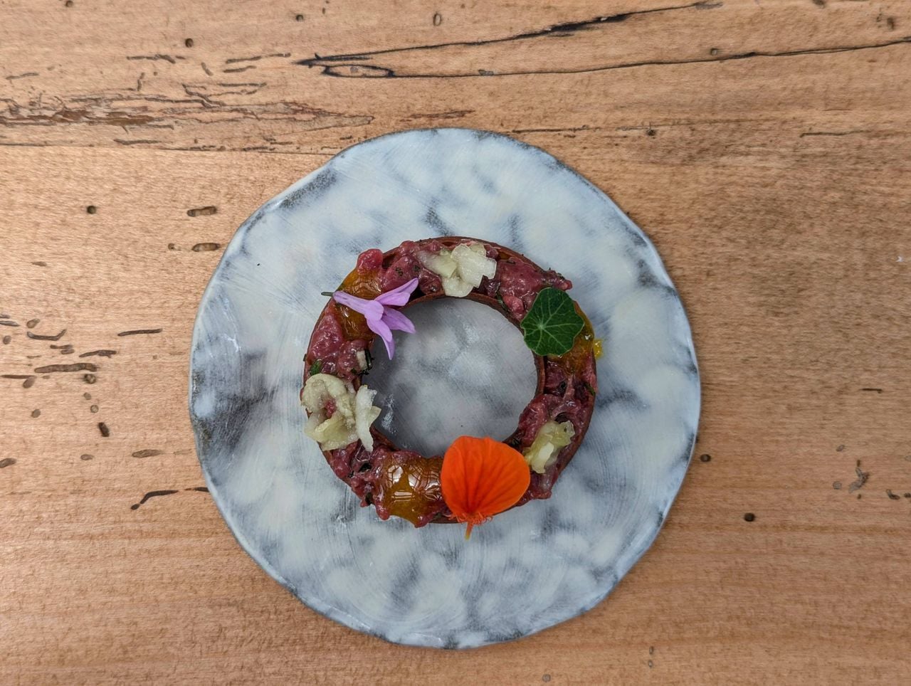 Beef tartare topped with edible petals